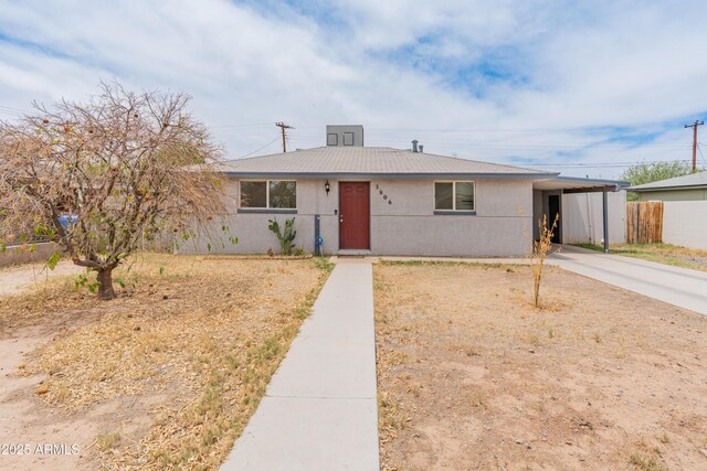 3806 N 64th Dr, Phoenix, AZ 85033 - bungalow with driveway, an attached carport, fence, and stucco siding
