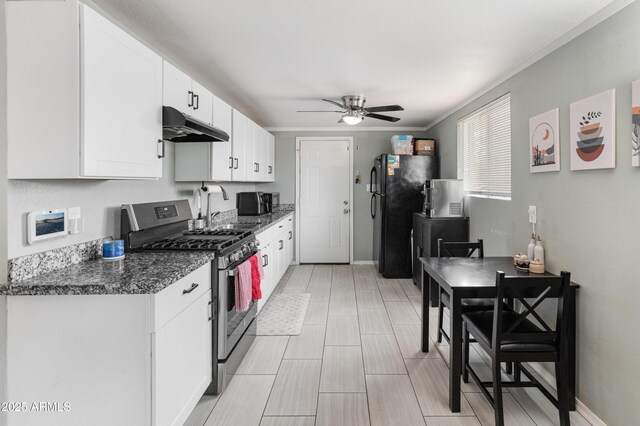 3806 N 64th Dr, Phoenix, AZ 85033 - kitchen with stainless steel appliances, under cabinet range hood, ceiling fan, white cabinetry, and a sink