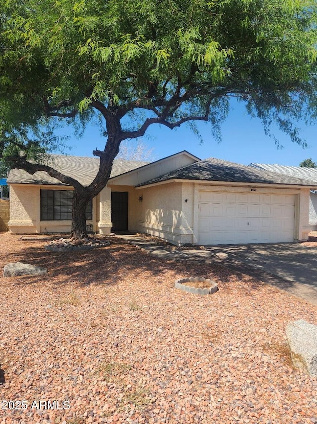 3329 W Ross Ave W, Phoenix, AZ 85027 - view of front facade featuring an attached garage, driveway, and stucco siding