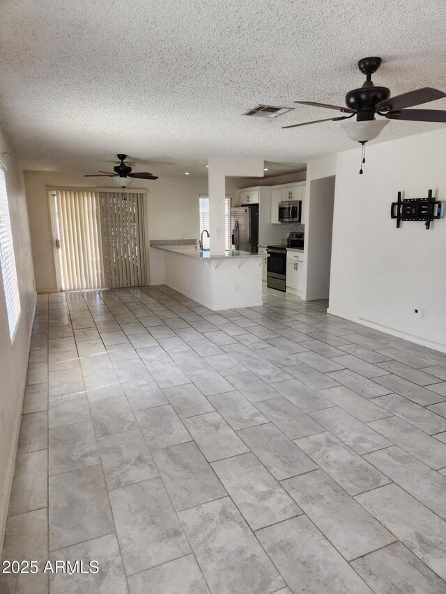 3329 W Ross Ave W, Phoenix, AZ 85027 - unfurnished living room featuring ceiling fan, a textured ceiling, and light tile patterned floors