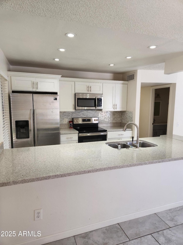 3329 W Ross Ave W, Phoenix, AZ 85027 - kitchen featuring stainless steel appliances, a textured ceiling, light stone countertops, white cabinets, and backsplash