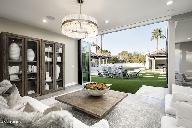 living room featuring an inviting chandelier and floor to ceiling windows