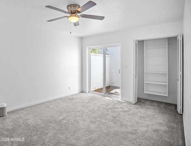 unfurnished bedroom featuring carpet flooring, baseboards, and ceiling fan
