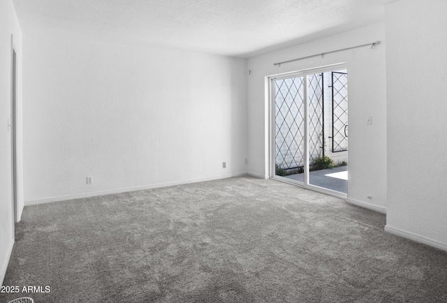 carpeted empty room with baseboards