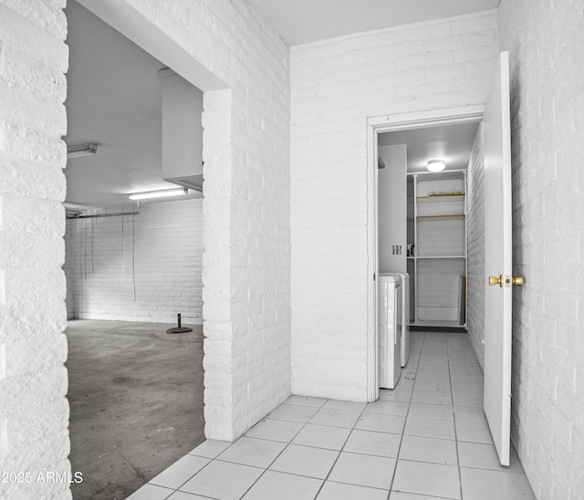 corridor with tile patterned flooring and washing machine and clothes dryer