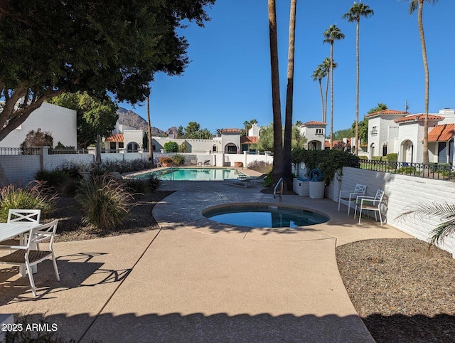 view of pool with a community hot tub and a patio