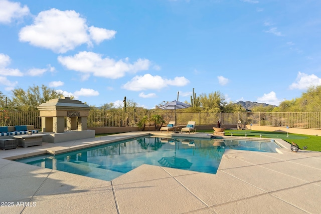 view of pool with a patio, fence, and outdoor lounge area