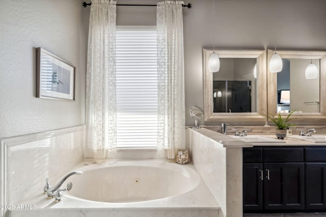 full bathroom featuring a bath and double vanity