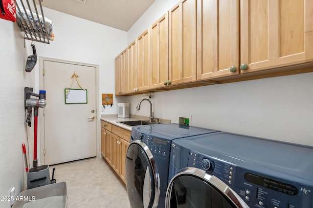washroom with cabinet space, washer and clothes dryer, and light tile patterned floors