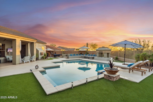 pool at dusk featuring an outdoor hangout area and a patio area