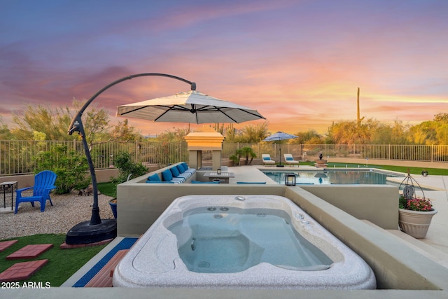 view of pool featuring an outdoor hot tub, a fenced backyard, and a patio