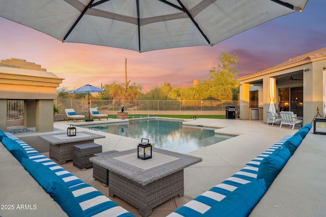 view of swimming pool featuring a patio, a fenced backyard, grilling area, and an outdoor living space