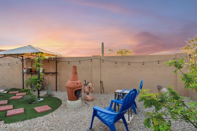 view of patio terrace at dusk