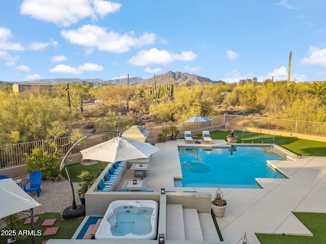 view of swimming pool with a patio, a mountain view, and a fenced backyard