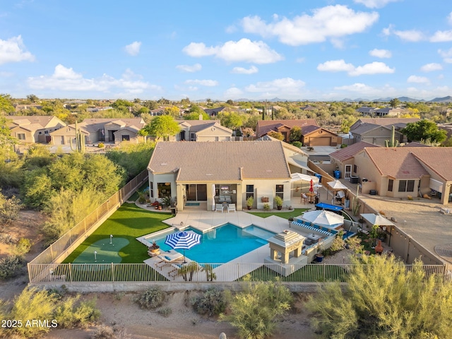 view of swimming pool featuring a fenced backyard, a residential view, a putting area, and a patio