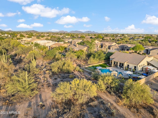view of property location featuring nearby suburban area, mountains, and a pool area
