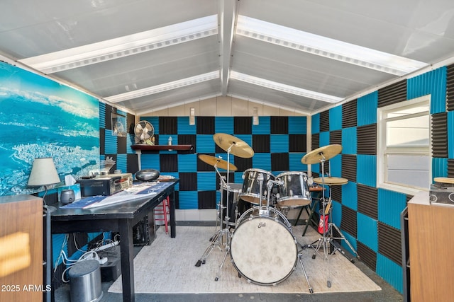 home office with lofted ceiling and wallpapered walls