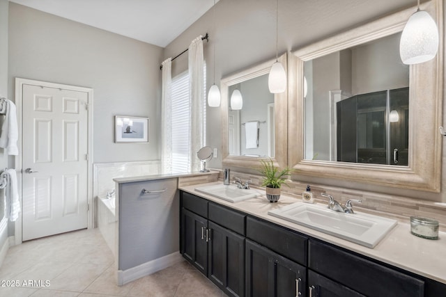 bathroom with tile patterned flooring, double vanity, and a bath