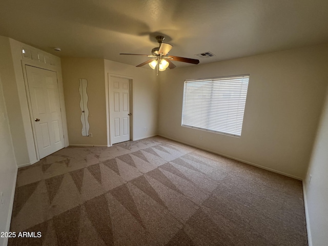 13004 W Saint Moritz Ln, El Mirage, AZ 85335 - unfurnished bedroom featuring light carpet and ceiling fan