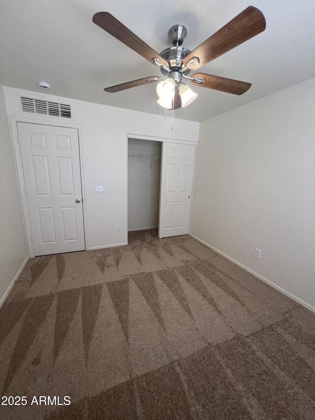 13004 W Saint Moritz Ln, El Mirage, AZ 85335 - unfurnished bedroom featuring carpet, a closet, and a ceiling fan