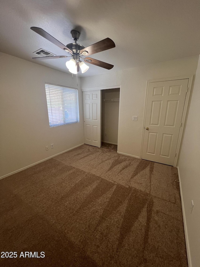 13004 W Saint Moritz Ln, El Mirage, AZ 85335 - unfurnished bedroom featuring a closet, carpet floors, and a ceiling fan