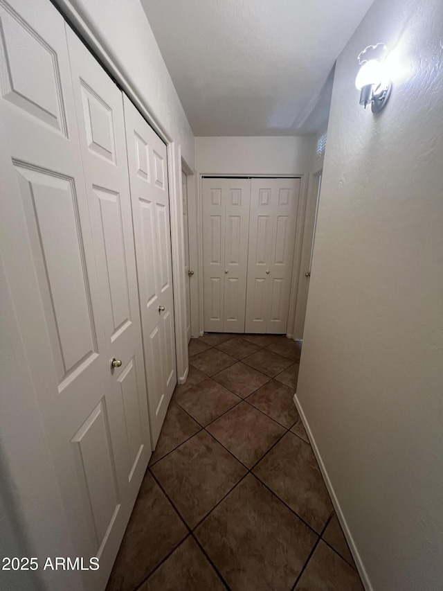 13004 W Saint Moritz Ln, El Mirage, AZ 85335 - hallway with dark tile patterned floors and baseboards
