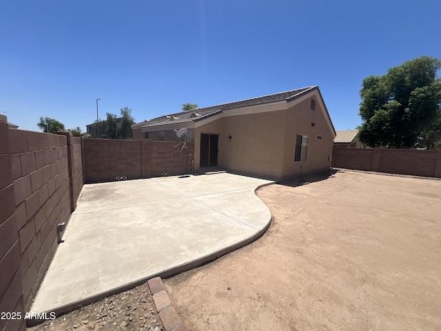13004 W Saint Moritz Ln, El Mirage, AZ 85335 - back of property featuring a patio area, a fenced backyard, and stucco siding