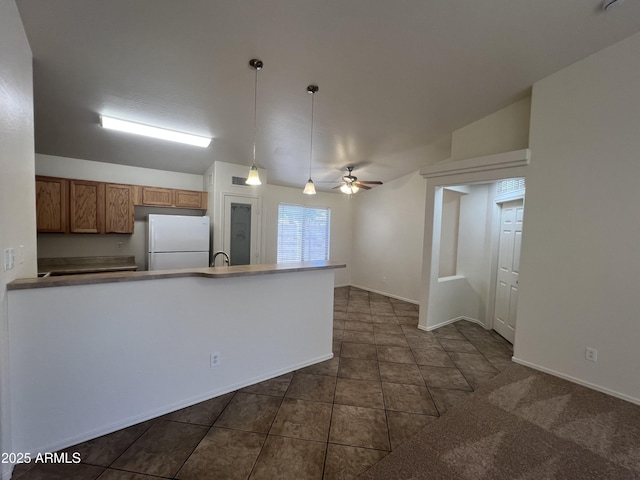 13004 W Saint Moritz Ln, El Mirage, AZ 85335 - kitchen featuring freestanding refrigerator, a ceiling fan, brown cabinets, hanging light fixtures, and dark tile patterned floors