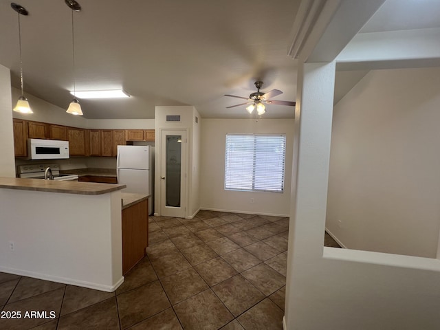 13004 W Saint Moritz Ln, El Mirage, AZ 85335 - kitchen with white appliances, brown cabinets, dark tile patterned flooring, decorative light fixtures, and a ceiling fan