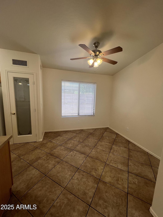 13004 W Saint Moritz Ln, El Mirage, AZ 85335 - spare room with dark tile patterned flooring and a ceiling fan