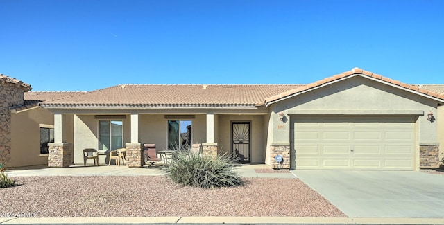 ranch-style home featuring a porch, stucco siding, an attached garage, and driveway