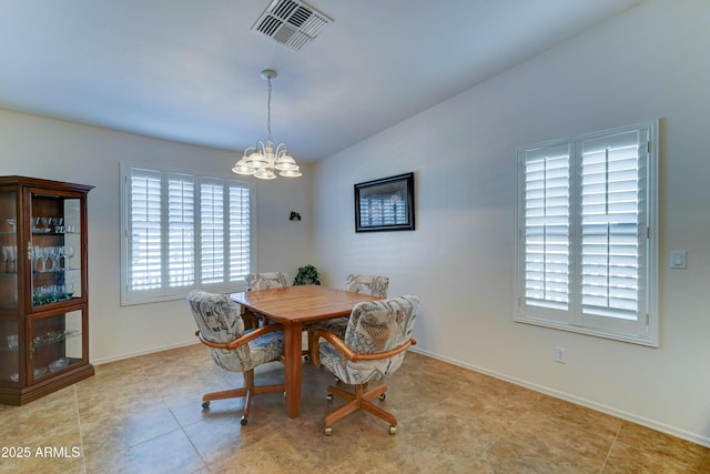 dining area featuring visible vents, a notable chandelier, baseboards, light tile patterned flooring, and lofted ceiling