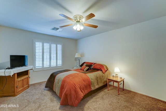 bedroom featuring baseboards, light carpet, visible vents, and a ceiling fan