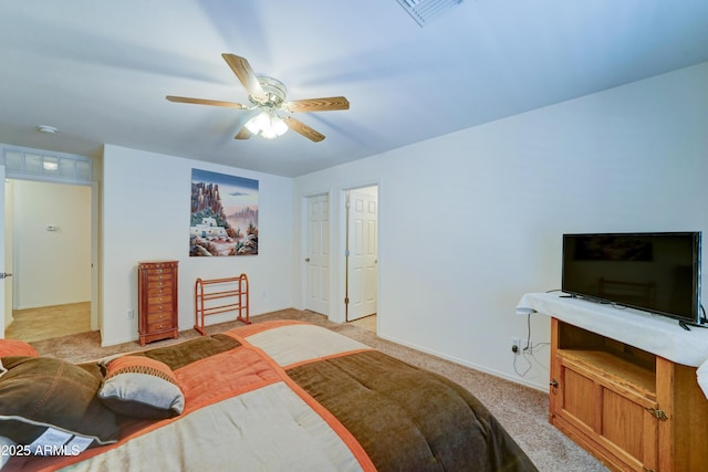 bedroom featuring visible vents, light carpet, baseboards, and ceiling fan