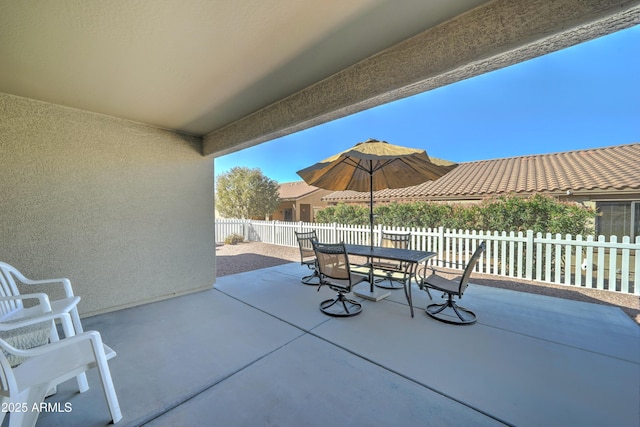 view of patio with outdoor dining space and a fenced backyard