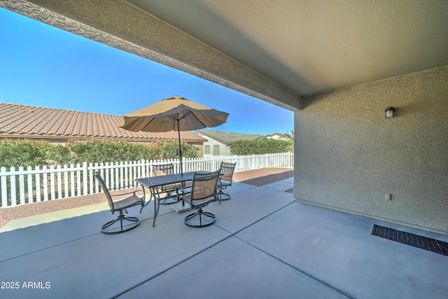 view of patio / terrace with outdoor dining space and fence