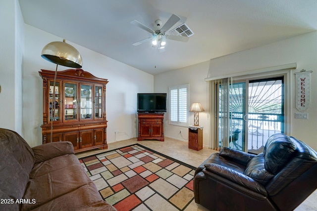 living area featuring visible vents, lofted ceiling, light colored carpet, and a ceiling fan