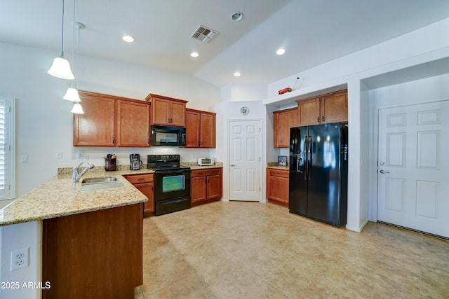 kitchen with visible vents, black appliances, a sink, a peninsula, and brown cabinetry