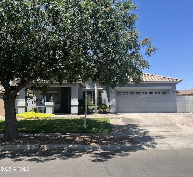 4140 E Claxton Ave, Gilbert, AZ 85297 - obstructed view of property with a garage, stucco siding, driveway, and a tiled roof