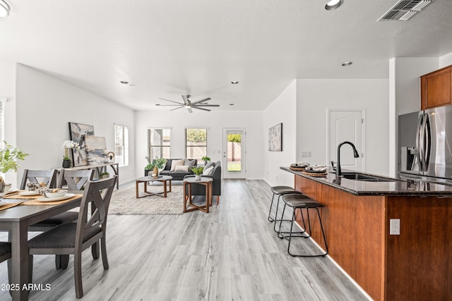 4140 E Claxton Ave, Gilbert, AZ 85297 - kitchen featuring stainless steel fridge with ice dispenser, recessed lighting, light wood-style floors, a sink, and dark stone counters
