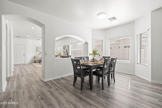4140 E Claxton Ave, Gilbert, AZ 85297 - dining room featuring wood finished floors, baseboards, recessed lighting, and arched walkways