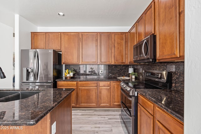 4140 E Claxton Ave, Gilbert, AZ 85297 - kitchen with stainless steel appliances, a sink, brown cabinets, light wood-type flooring, and recessed lighting