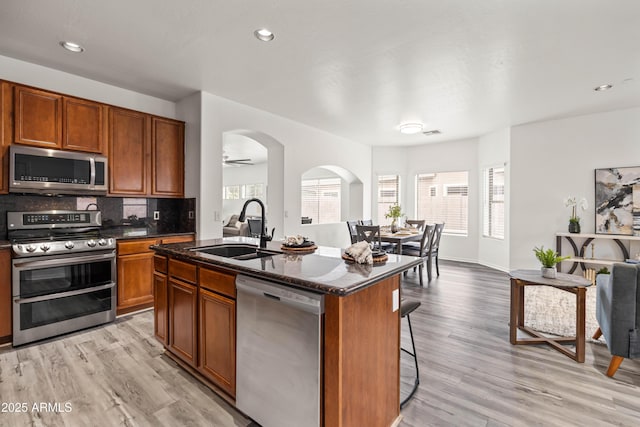 4140 E Claxton Ave, Gilbert, AZ 85297 - kitchen with stainless steel appliances, a sink, light wood-style flooring, brown cabinetry, and recessed lighting