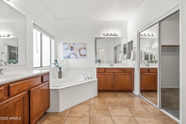 4140 E Claxton Ave, Gilbert, AZ 85297 - bathroom with two vanities, a bath, and tile patterned floors