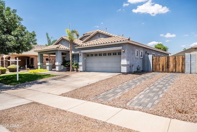 4140 E Claxton Ave, Gilbert, AZ 85297 - view of front of house featuring stucco siding, an attached garage, driveway, and a tile roof