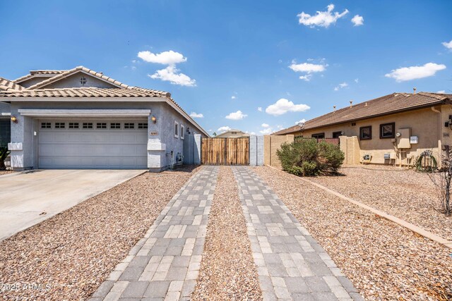 4140 E Claxton Ave, Gilbert, AZ 85297 - view of front of house featuring stucco siding, driveway, a gate, an attached garage, and a tiled roof