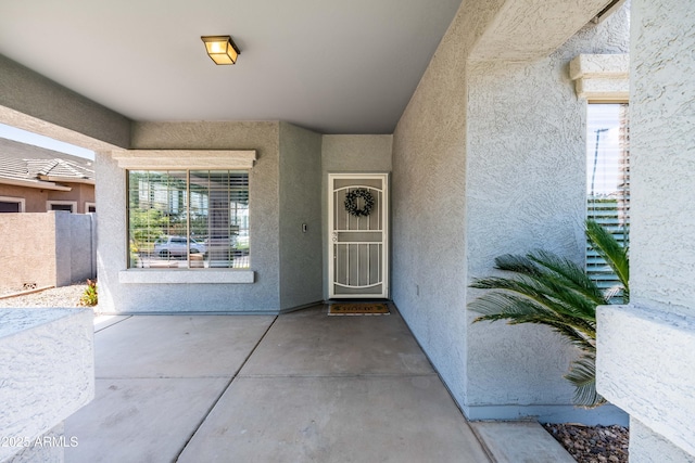 4140 E Claxton Ave, Gilbert, AZ 85297 - view of exterior entry with stucco siding and a patio