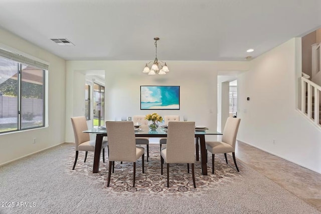 dining area with visible vents, baseboards, and an inviting chandelier