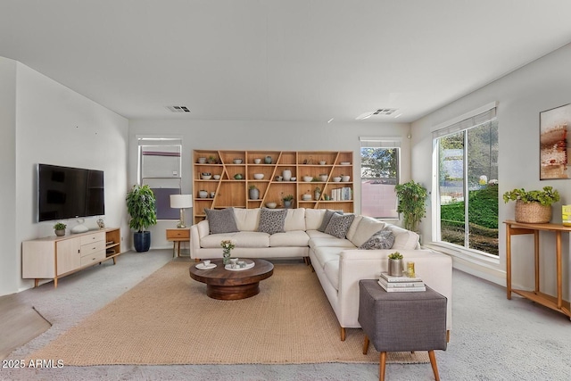 living room with visible vents and light carpet