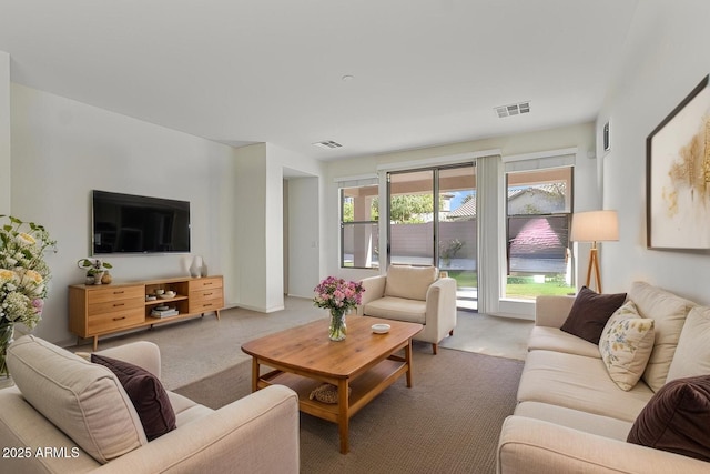 living room featuring visible vents and carpet flooring
